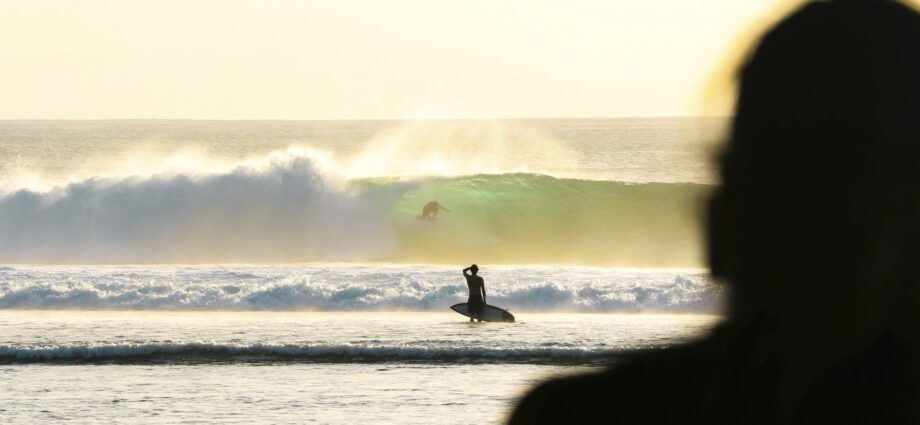 Surfer on a deserted beach in Indonesia