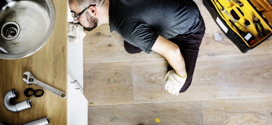 Man fixing kitchen sink
