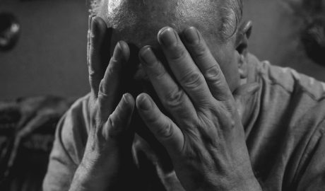 Photo by Kindel Media: https://www.pexels.com/photo/a-grayscale-photo-of-an-elderly-man-covering-his-face-8172278/