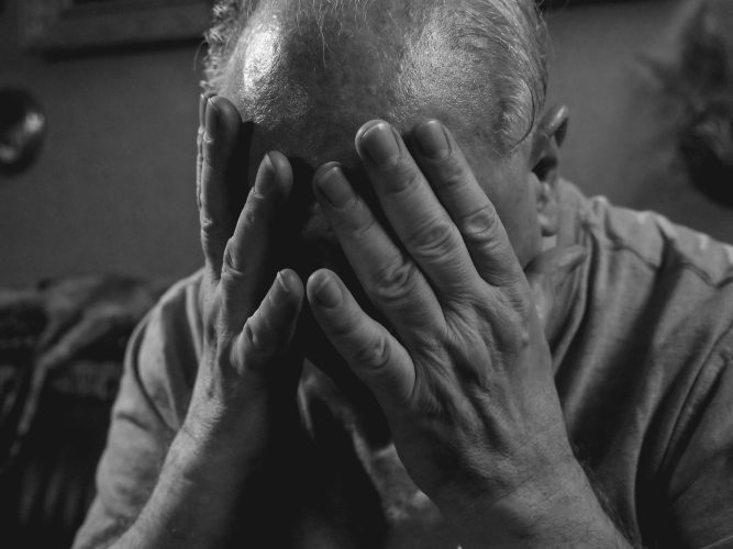 Photo by Kindel Media: https://www.pexels.com/photo/a-grayscale-photo-of-an-elderly-man-covering-his-face-8172278/