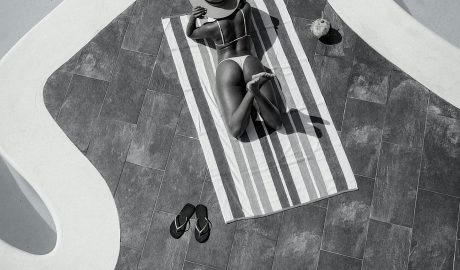 Photo by Demar Cratic : https://www.pexels.com/photo/woman-sunbathing-by-the-pool-17676938/